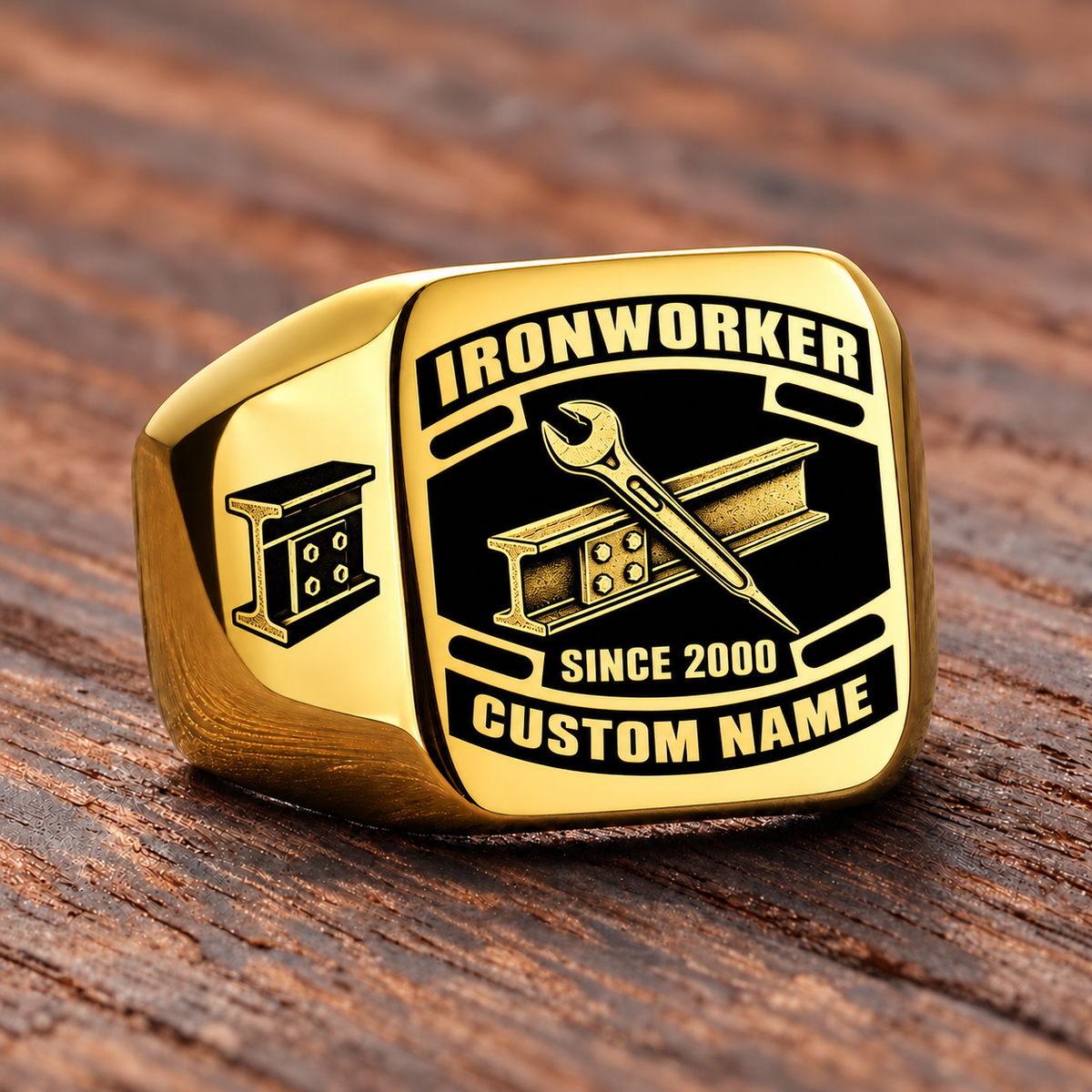 Gold-finish Ironworker Black Face Badge ring with bolted structural I-beam and pointed spud wrench artwork, shoulder bolted I-beam emblem and illustrated CUSTOM NAME and SINCE 2000 text