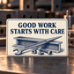 Ivory reverse of the Ironworker aluminum wallet card reading Good Work Starts with Care, with an indigo I-beam, spud wrench, bolts and nuts.