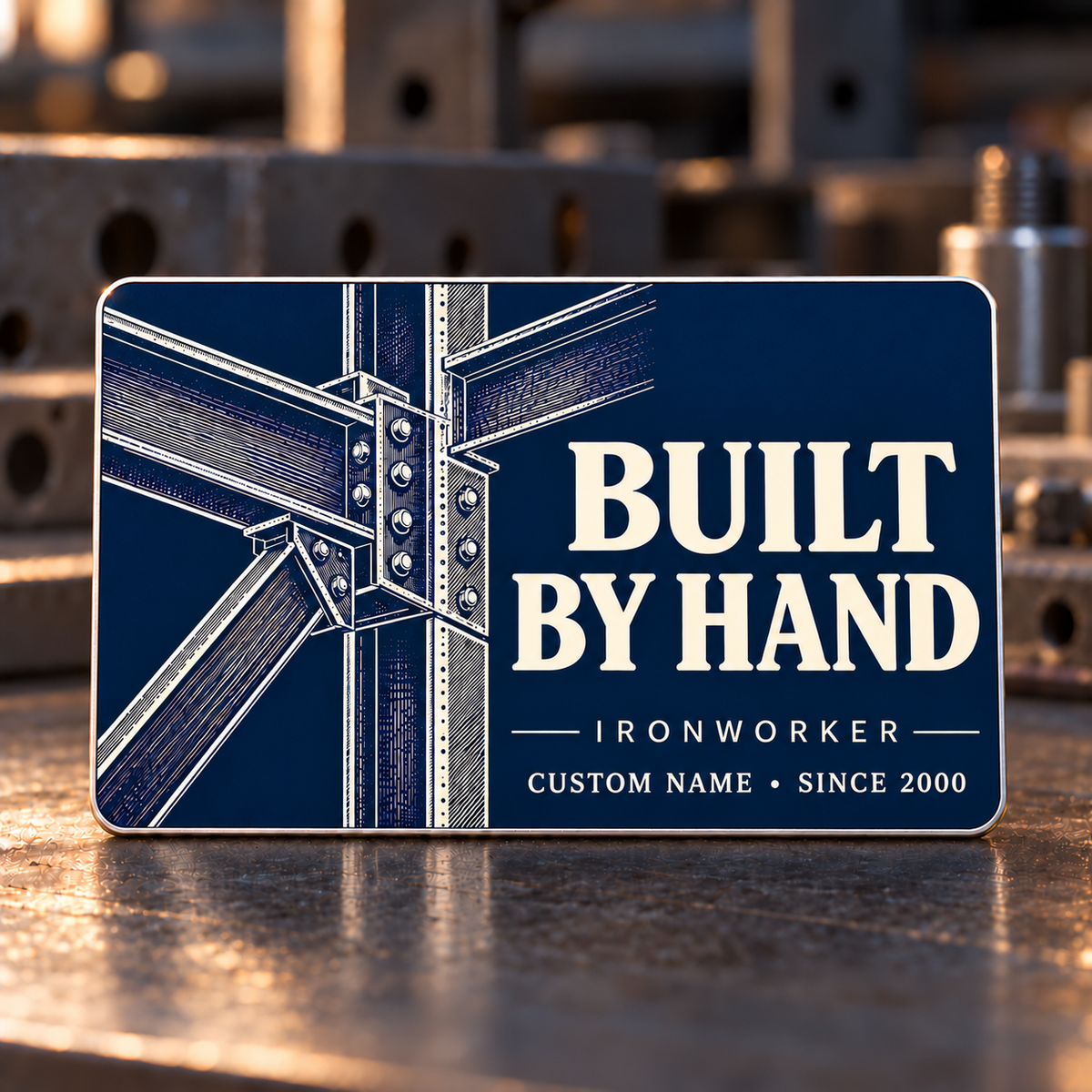 Ironworker Built by Hand aluminum wallet card with ivory I-beams and bolted structural-steel linework on an indigo front.
