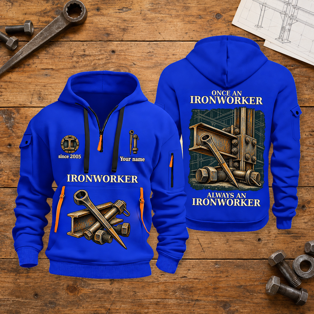 Ironworker Proud of the Trade Quarter-Zip Hoodie in Blue, full authentic front and back views with matching ironworker tools and equipment artwork, original sample name/year and once-and-always trade motto. On a ironworker workbench.