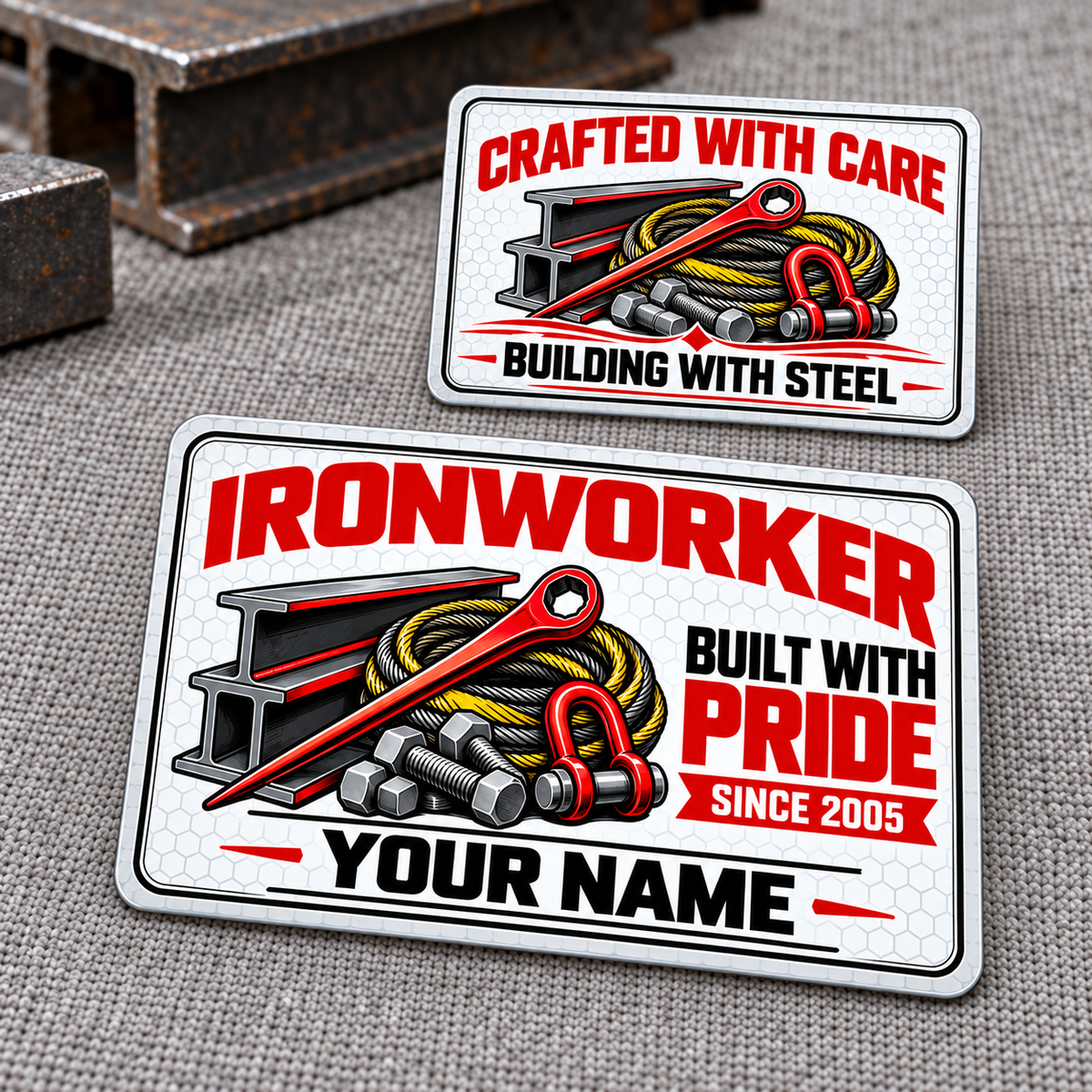 Front and reverse of an Ironworker Honeycomb Pride aluminum wallet card, with red lettering, white honeycomb, steel I-beams, a spud wrench, structural bolts and lifting sling artwork on gray woven cloth.
