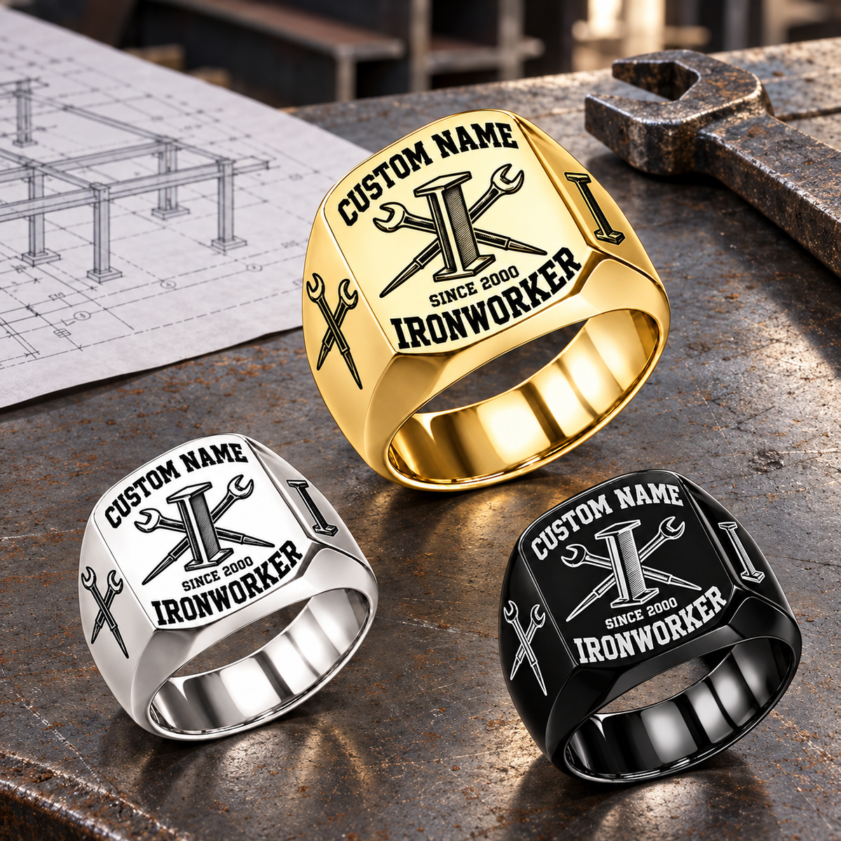 Ironworker Bold Lettering Signet Ring in Gold, Silver and Black, with Gold dominant on a stationary structural-steel planning bench.