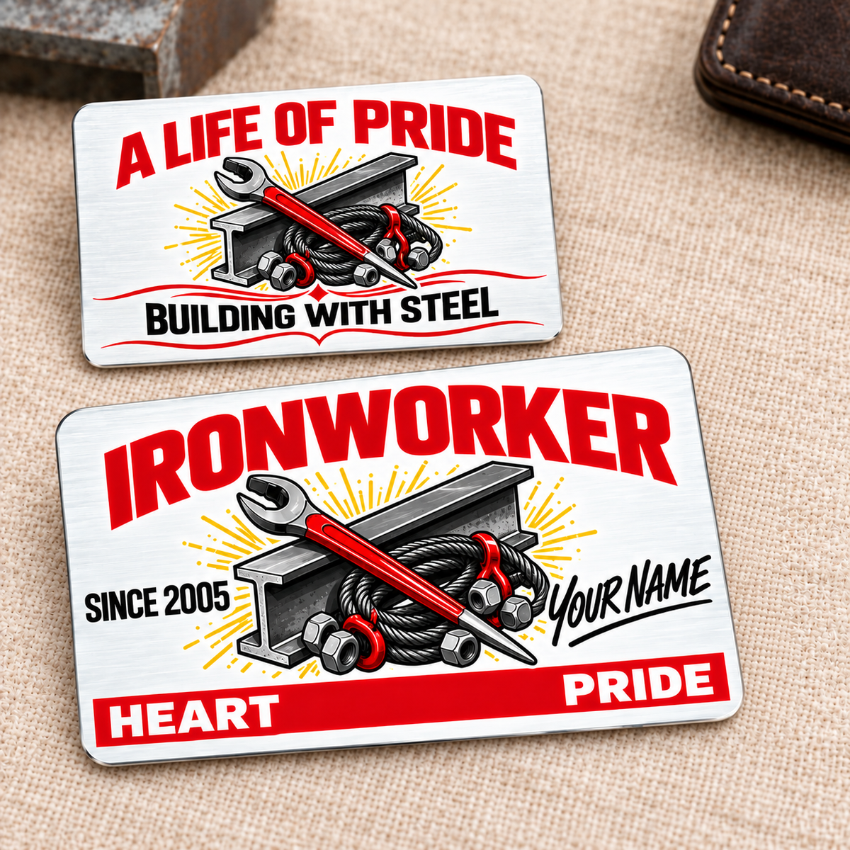 Front and reverse of an Ironworker Signature Classic aluminum wallet card on cream linen, with red title and Heart and Pride band, I-beam, tapered spud wrench, bolts and rigging sling artwork.