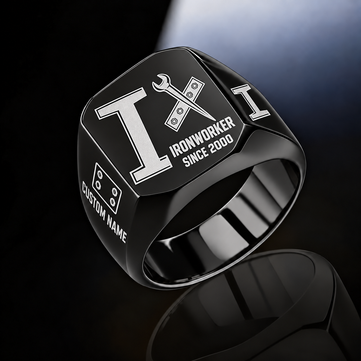 Black-finish Ironworker Split Emblem signet ring with I-beam, bolted plate and pointed spud-wrench engraving, and illustrated CUSTOM NAME and SINCE 2000 text