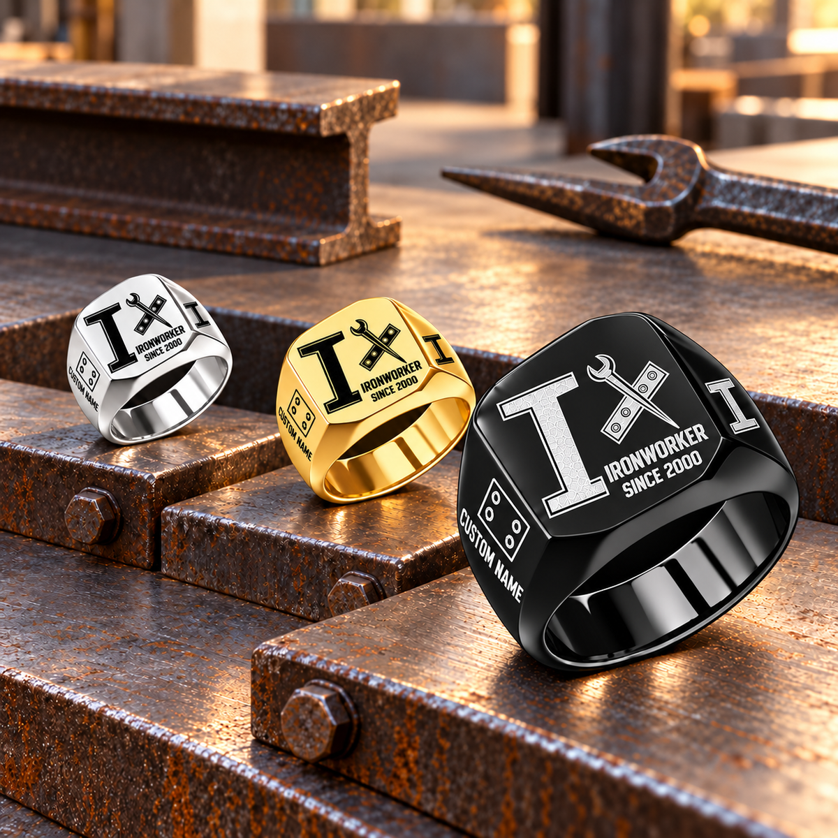 Black-led Ironworker Split Emblem rings on stepped steel plates, with Gold in the middle and Silver at left