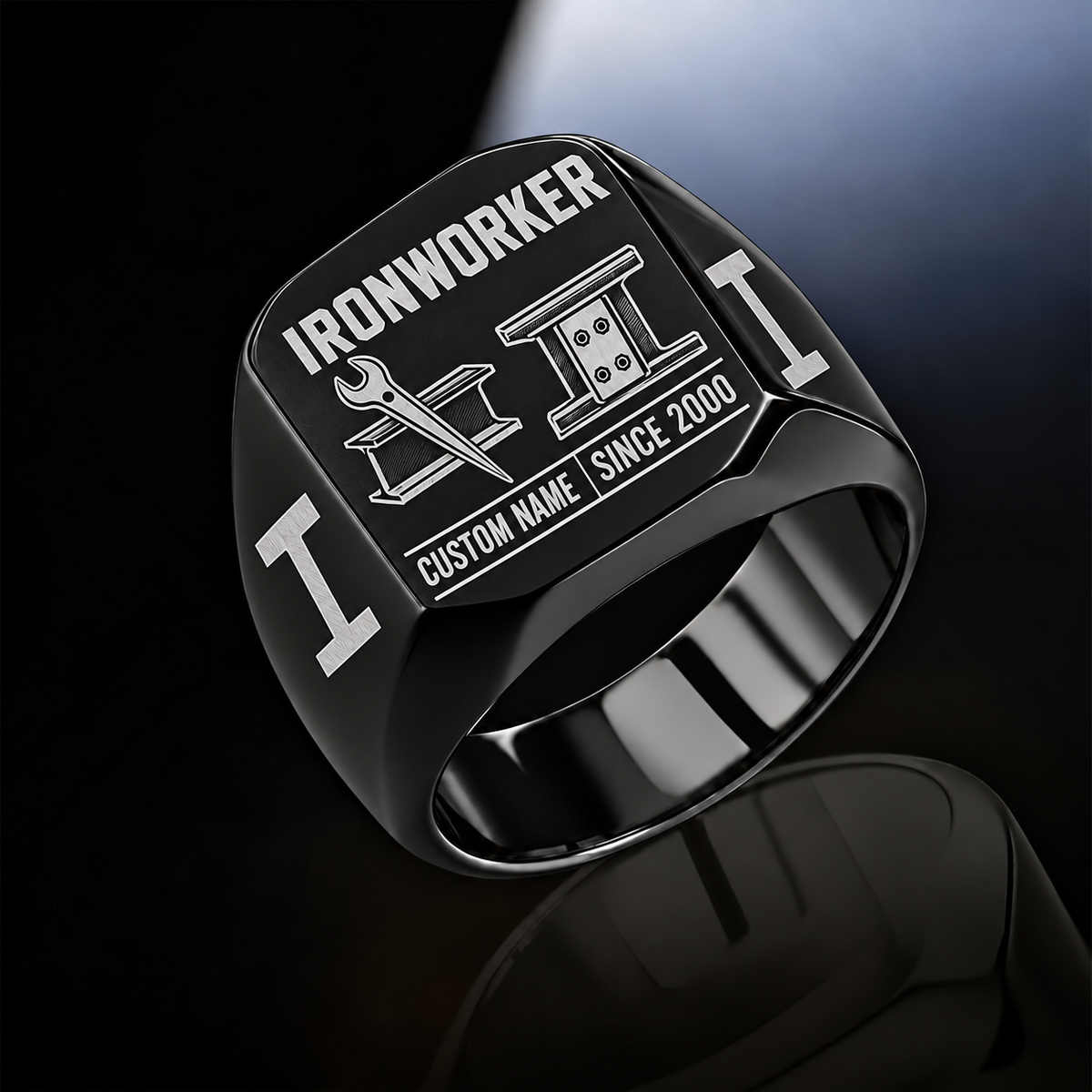 Black-finish Ironworker Twin Icons signet ring with spud-wrench and I-beam artwork beside a four-bolt splice-plate emblem, I-beam shoulders and illustrated CUSTOM NAME and SINCE 2000 text