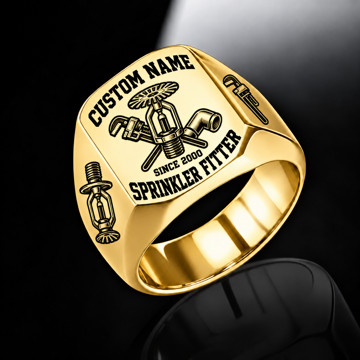 Gold-finish Sprinkler Fitter Bold Lettering signet ring with fire-sprinkler, pipe-wrench and pipe-elbow engraving, and illustrated CUSTOM NAME and SINCE 2000 text