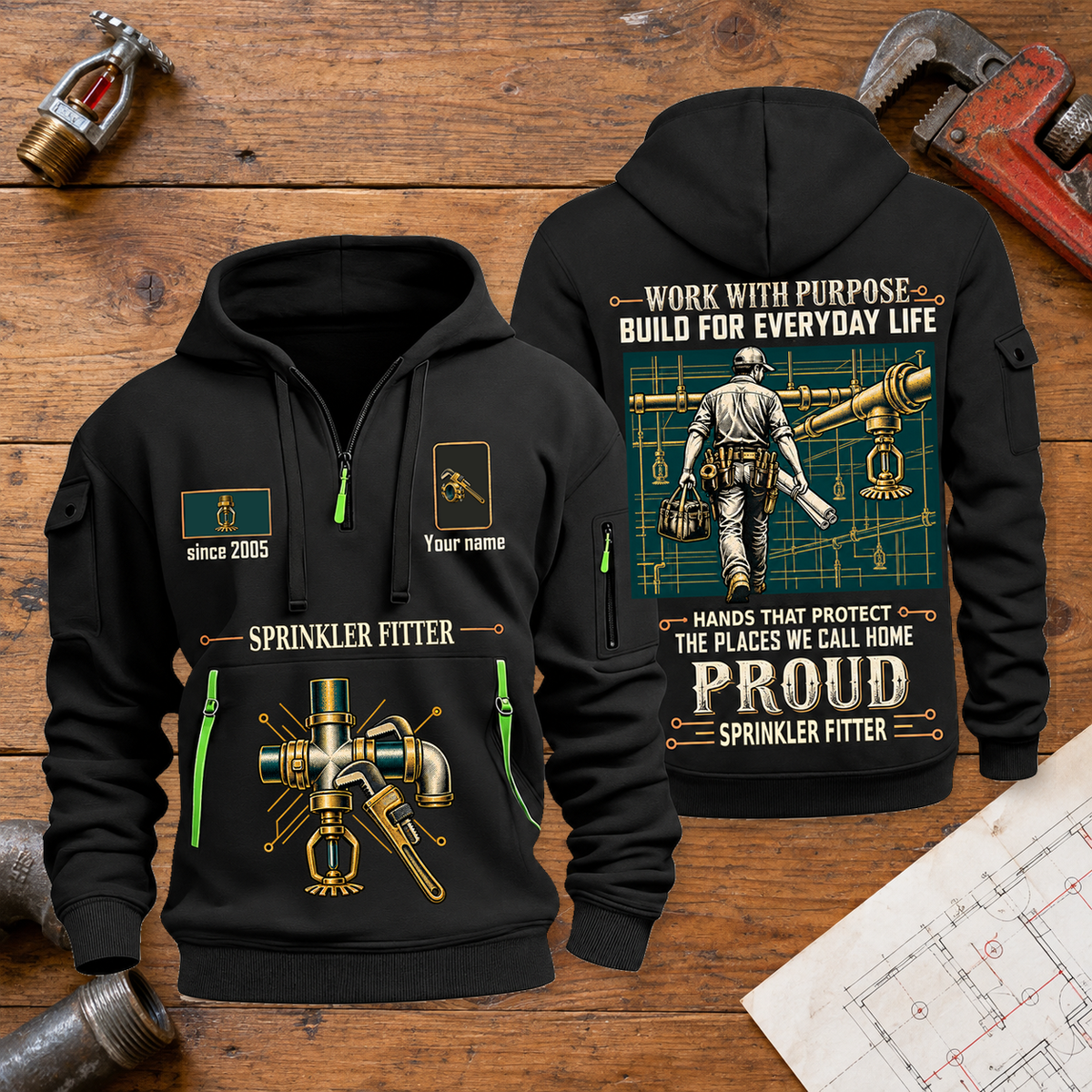 Sprinkler Fitter Built For The Everyday Quarter-Zip Hoodie in Black, full authentic front and back views with matching sprinkler fitter tools and equipment artwork, original sample name/year and Built For The Everyday planning theme. On a sprinkler fitter workbench.