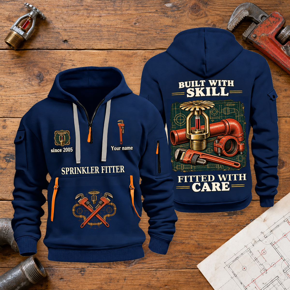 Sprinkler Fitter Built With Skill Quarter-Zip Hoodie in Navy, full authentic front and back views with matching sprinkler fitter tools and equipment artwork, original sample name/year and Built With Skill slogan. On a sprinkler fitter workbench.