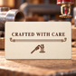 Ivory reverse of the Sprinkler Fitter Every Joint aluminum wallet card, with the words Crafted with Care, fine pipework lines and small pipe wrench and fire-sprinkler illustrations.