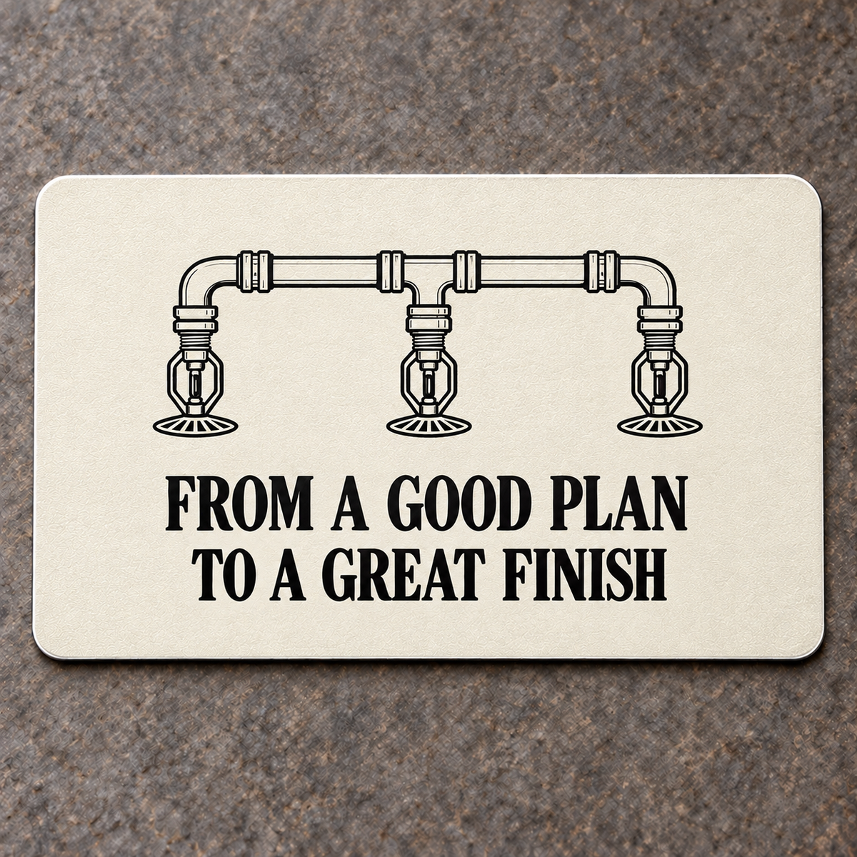 Ivory reverse of the Sprinkler Fitter First Line aluminum wallet card. Black fire-suppression pipe-plan illustration above FROM A GOOD PLAN TO A GREAT FINISH lettering.