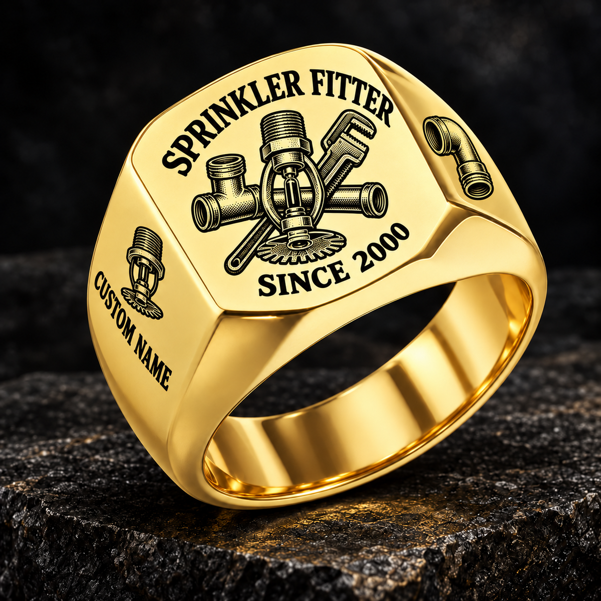 Gold-finish Sprinkler Fitter Heritage Emblem signet ring with pendent fire-sprinkler head, connected tee fitting and pipe wrench engraving, illustrated CUSTOM NAME and SINCE 2000 text