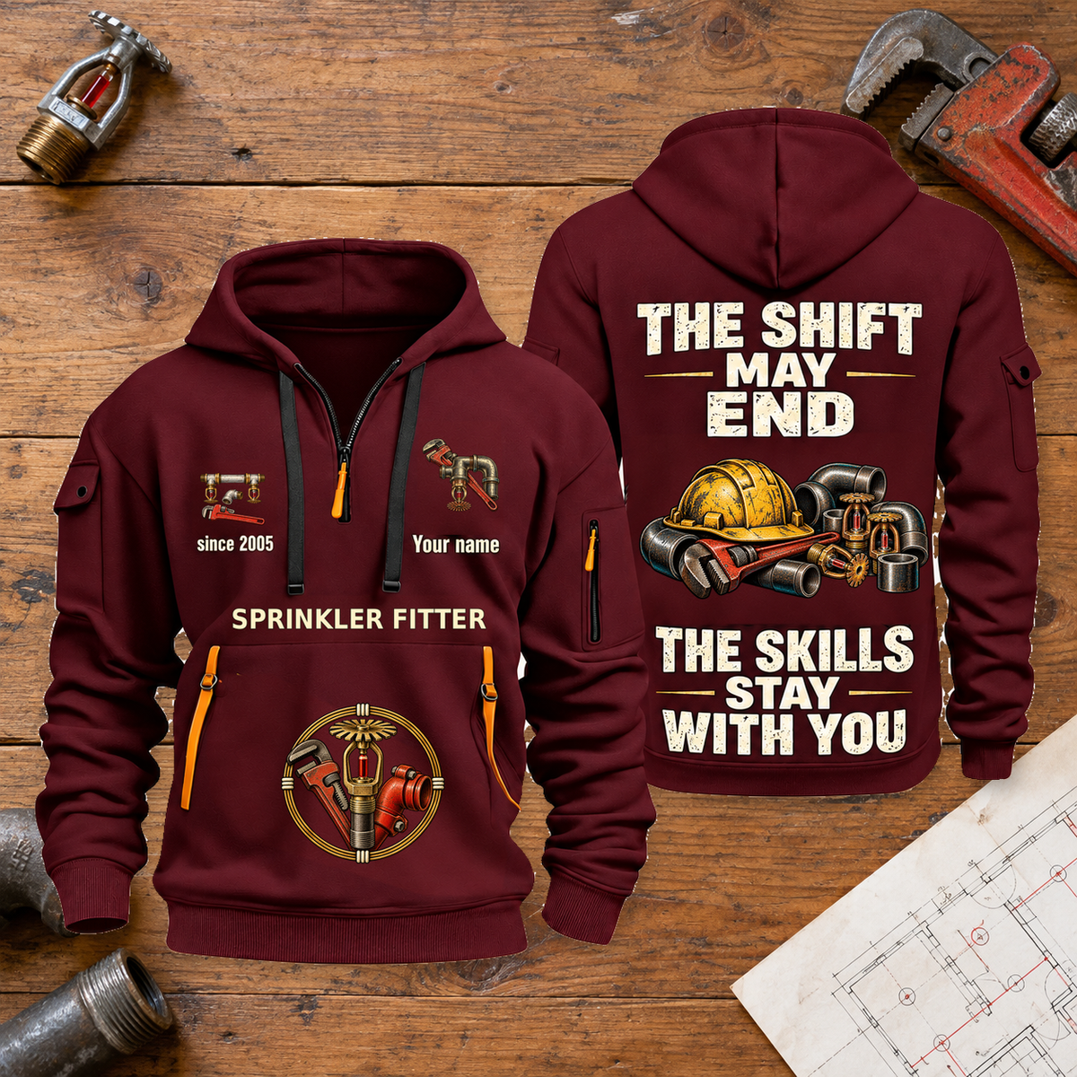 Sprinkler Fitter Skills Stay With You Quarter-Zip Hoodie in Wine Red, full authentic front and back views with matching sprinkler fitter tools and equipment artwork, original sample name/year and Skills Stay With You slogan. On a sprinkler fitter workbench.
