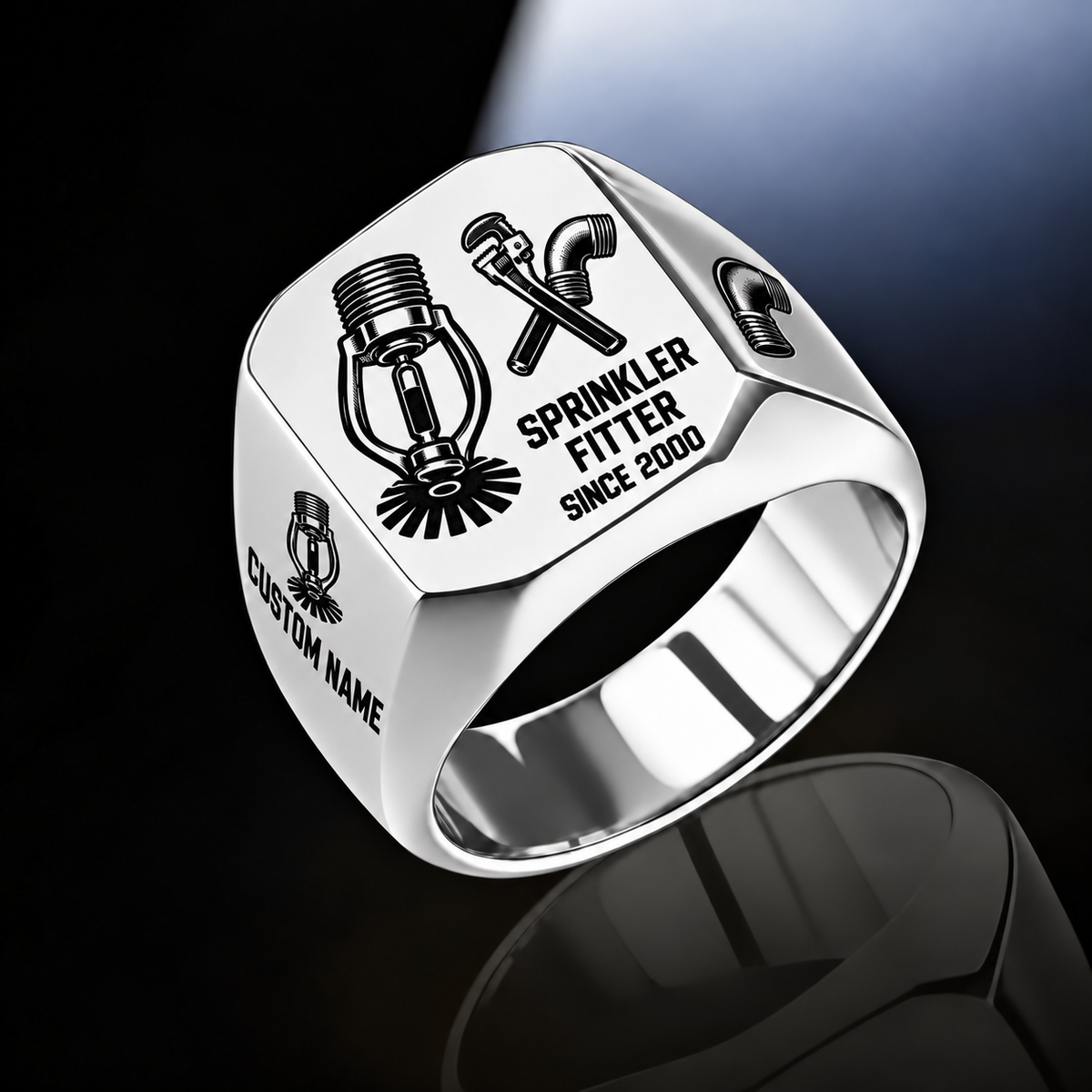 Sprinkler Fitter Split Emblem ring in Silver, showing fire-sprinkler head and pipe-tool artwork with CUSTOM NAME and SINCE 2000 sample engraving.