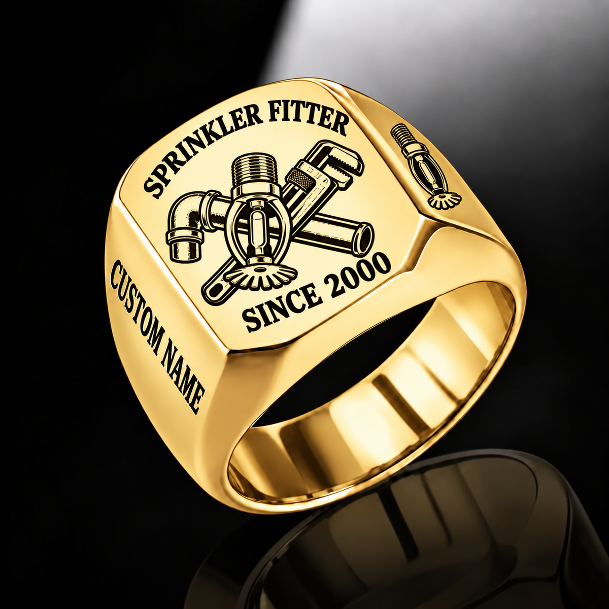 Gold-finish Sprinkler Fitter Trade Emblem signet ring with pendent fire sprinkler, connected pipe fitting, pipe wrench and illustrated CUSTOM NAME and SINCE 2000 text
