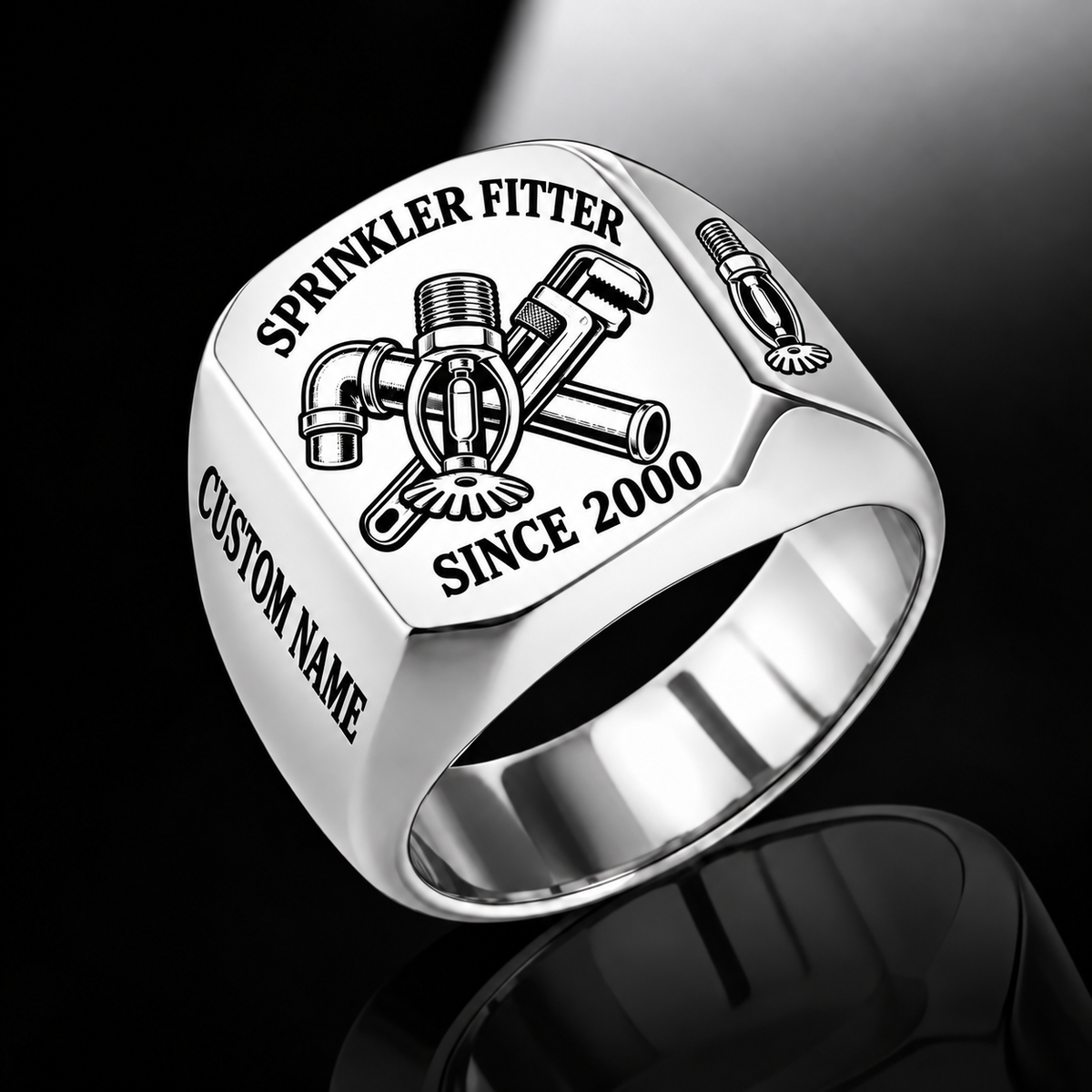 Silver-finish Sprinkler Fitter Trade Emblem signet ring with pendent fire sprinkler, connected pipe fitting, pipe wrench and illustrated CUSTOM NAME and SINCE 2000 text
