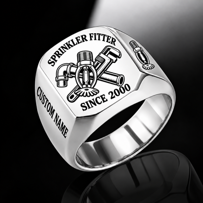 Silver-finish Sprinkler Fitter Trade Emblem signet ring with pendent fire sprinkler, connected pipe fitting, pipe wrench and illustrated CUSTOM NAME and SINCE 2000 text