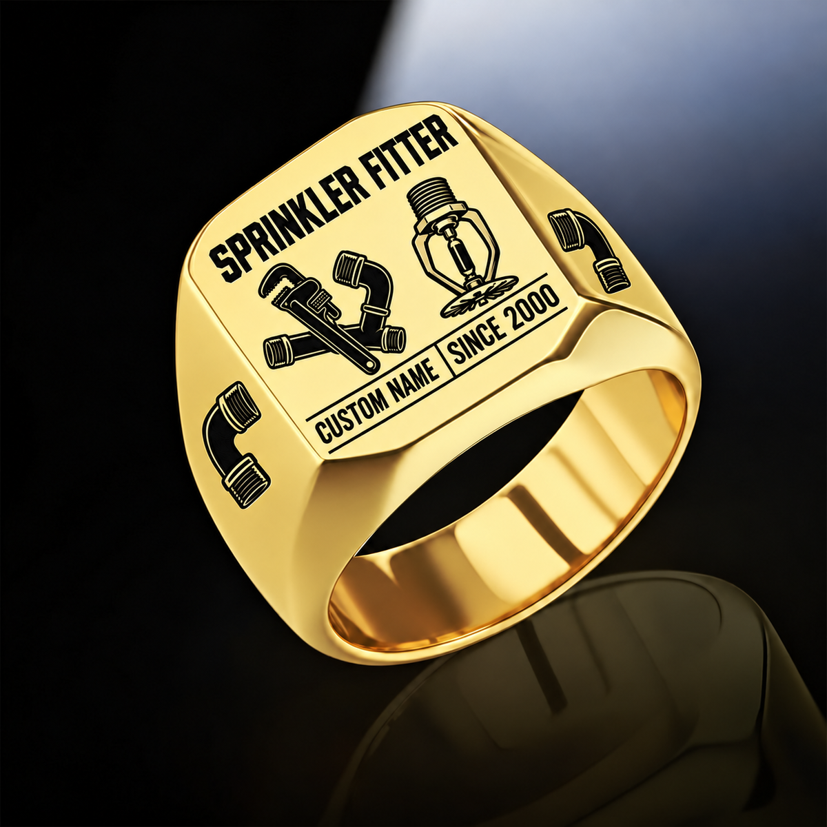 Gold-finish Sprinkler Fitter Twin Icons signet ring with pipe wrench and connected fittings beside a pendent fire sprinkler, elbow shoulder emblems and illustrated CUSTOM NAME and SINCE 2000 text
