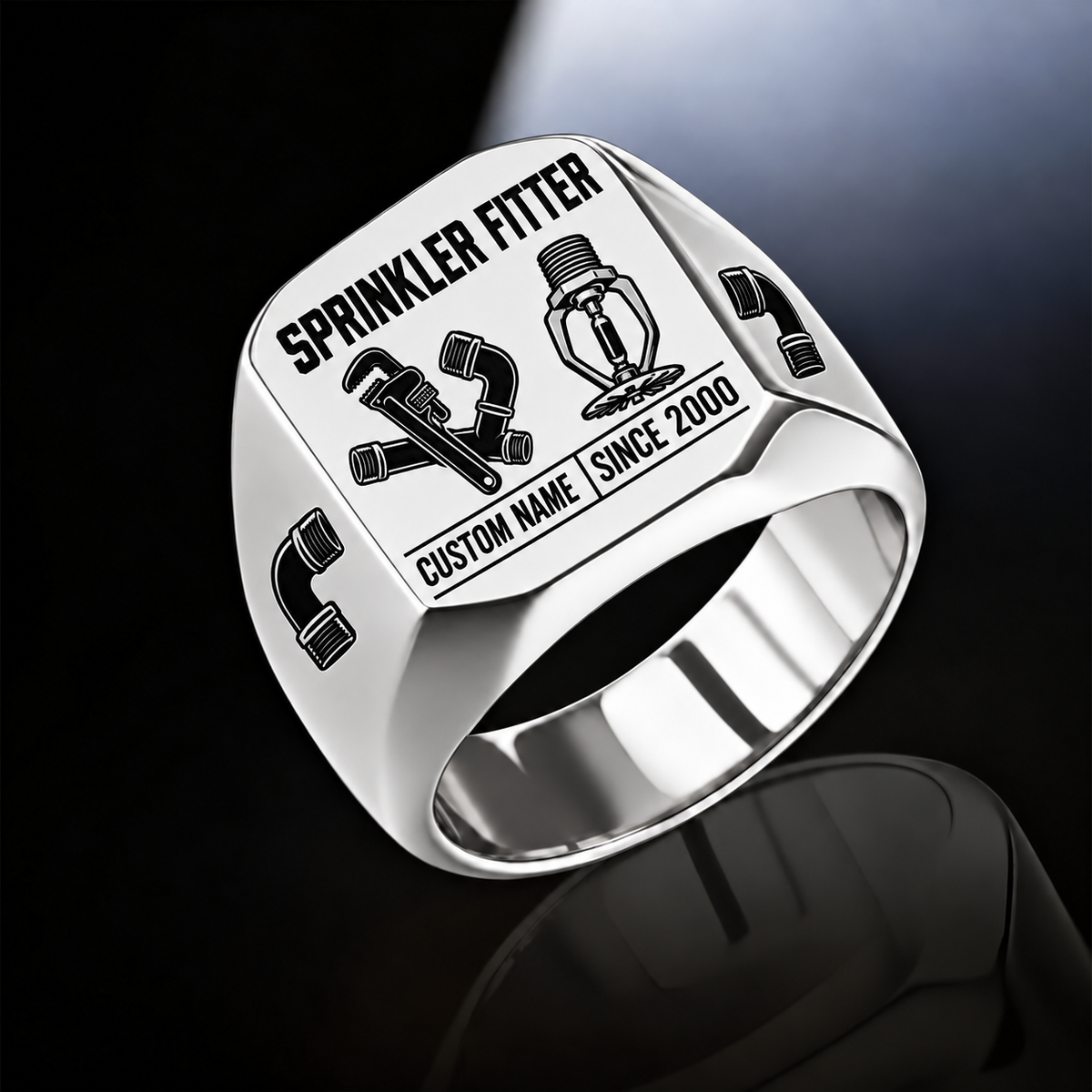Silver-finish Sprinkler Fitter Twin Icons signet ring with pipe wrench and connected fittings beside a pendent fire sprinkler, elbow shoulder emblems and illustrated CUSTOM NAME and SINCE 2000 text
