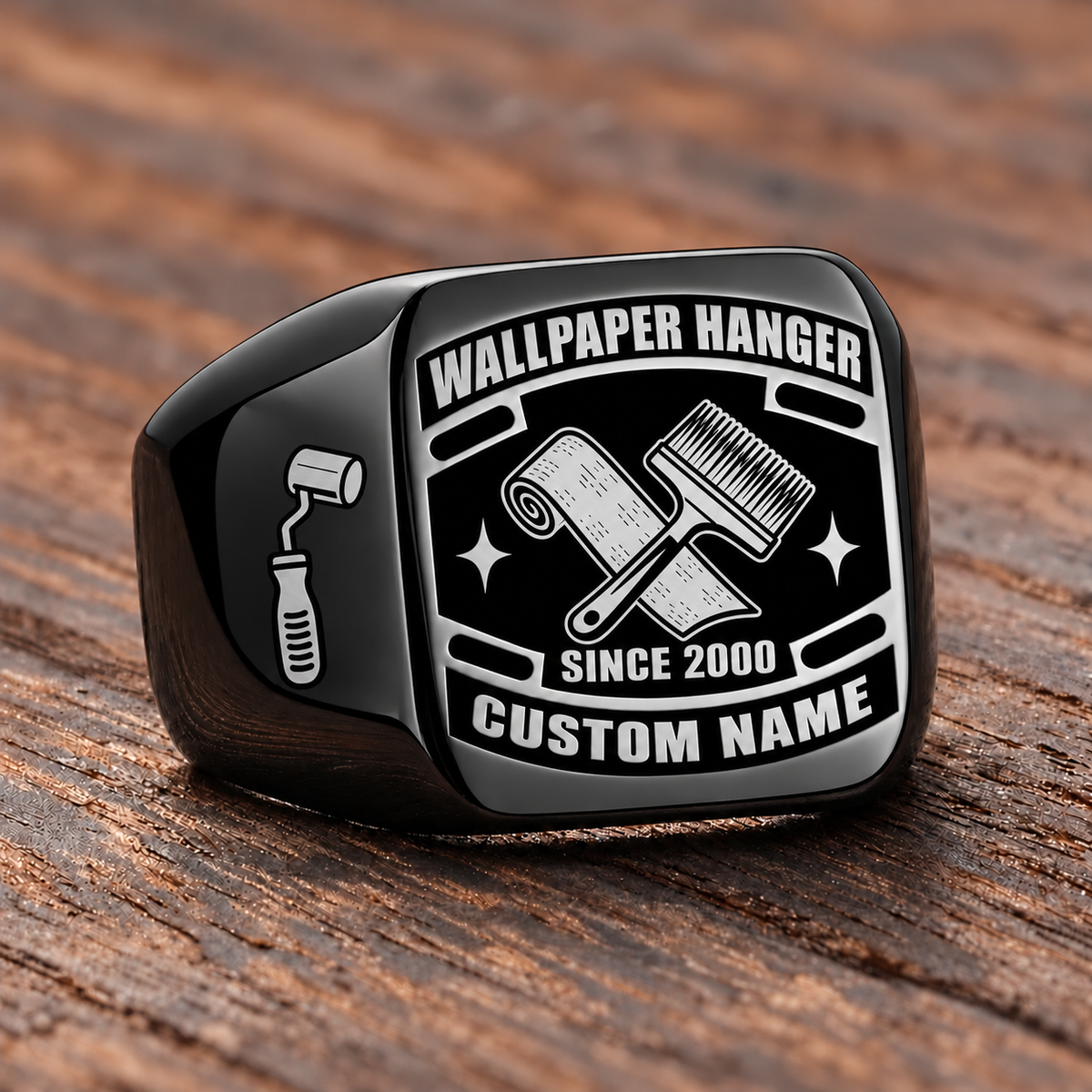 Black-finish Wallpaper Hanger Black Face Badge signet ring with crossed wallpaper roll and pasting brush, smooth seam-roller shoulder icon, and illustrated CUSTOM NAME and SINCE 2000 text