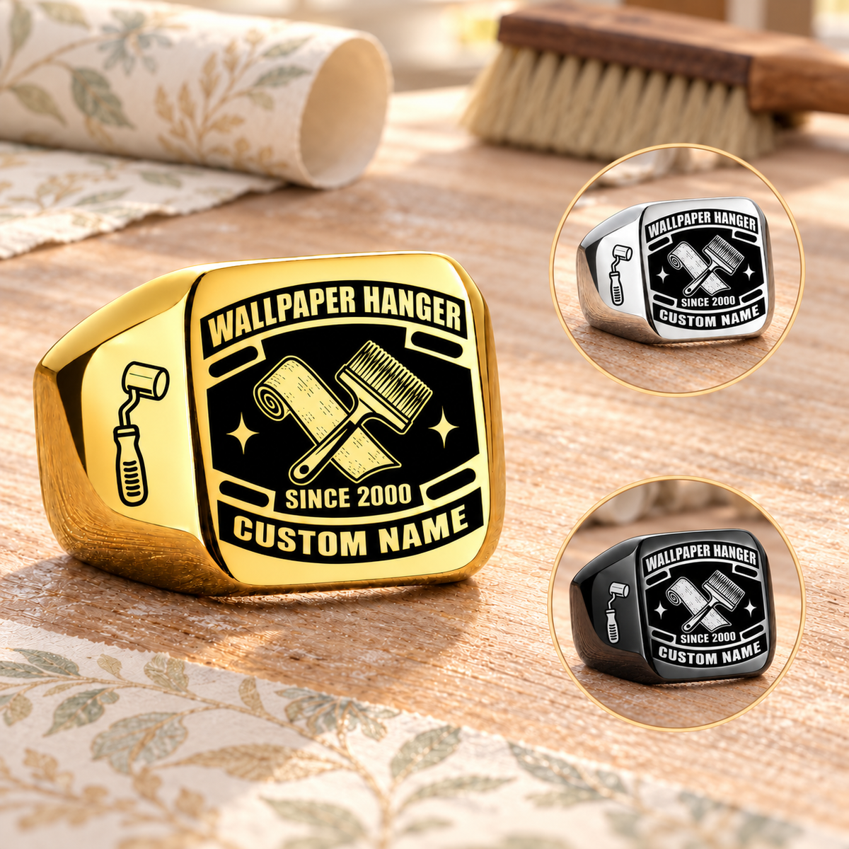 Wallpaper Hanger Black Face Badge rings: dominant Gold with separate smaller Silver and Black circular insets on a stationary wallpaper pasting table