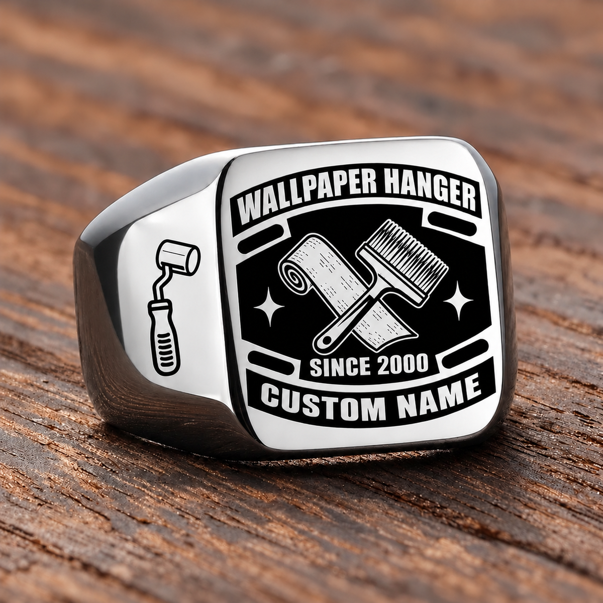 Silver-finish Wallpaper Hanger Black Face Badge signet ring with crossed wallpaper roll and pasting brush, smooth seam-roller shoulder icon, and illustrated CUSTOM NAME and SINCE 2000 text