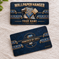 Front and reverse views of one Wallpaper Hanger Craft Camo aluminum wallet card on cream woven fabric, showing navy textured camouflage, copper-toned lettering, blue accents, wallpaper rolls, seam roller, smoothing brush and curled patterned-paper borders.