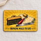 Wallpaper Hanger Golden Milestone aluminum wallet card reverse on cream linen, with a smoothing brush, seam roller, wallpaper roll, straightedge and Bringing Walls to Life text.