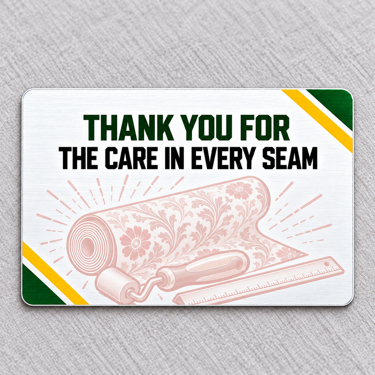 Reverse of the Wallpaper Hanger Green Band aluminum wallet card, with THANK YOU FOR THE CARE IN EVERY SEAM, pale pink wallpaper-tool artwork and green and yellow corner bands.