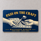 Navy front of the Wallpaper Hanger Pass on the Craft aluminum wallet card, showing two hands passing a seam roller over patterned wallpaper with gold lettering.