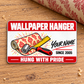Front of the Wallpaper Hanger Red Header aluminum wallet card with a wallpaper roll, seam roller, yellow rule, illustrative name and year, and Hung With Pride footer.