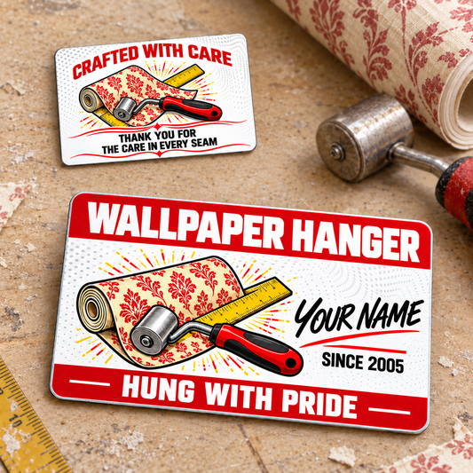 Wallpaper Hanger Red Header aluminum wallet card with a dominant diagonal front and smaller reverse view on a wallpapering workbench; one two-sided card.