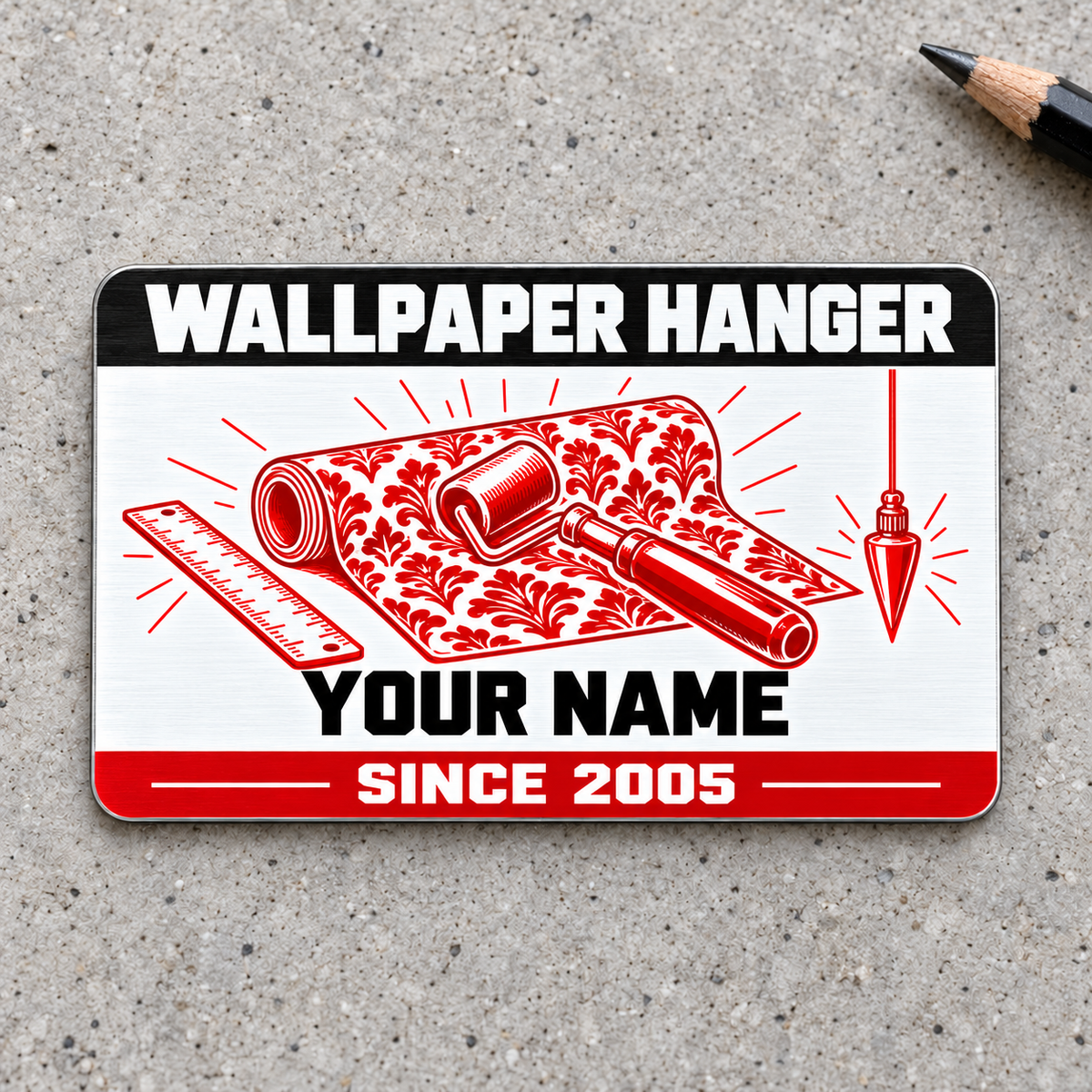 Front of the Wallpaper Hanger Red Monochrome aluminum wallet card on light-gray concrete, with illustrative YOUR NAME and SINCE 2005 text.