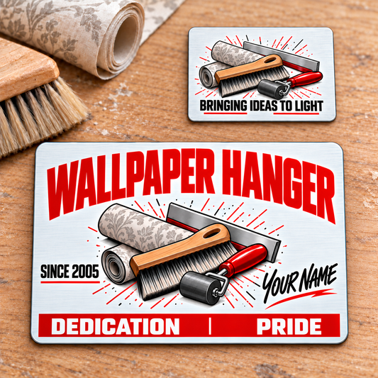 Front and reverse of the Wallpaper Hanger Signature Modern aluminum wallet card on a wallpaper worktable, with a wallpaper roll, smoothing brush, seam roller and straightedge.