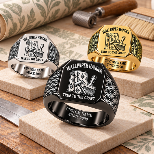 Wallpaper Hanger True to the Craft signet rings in a Black-led stepped arrangement with Silver and Gold finishes on a stationary wallpaper worktable