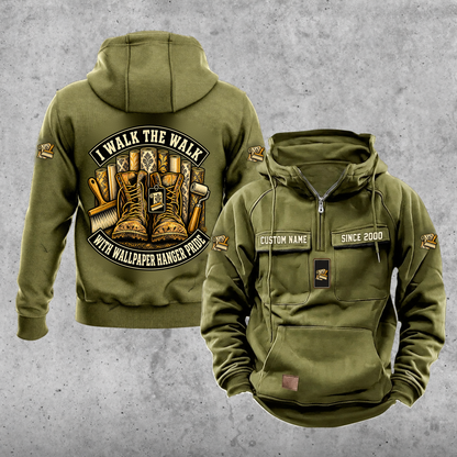 Wallpaper Hanger Walk the Walk Badge Vintage Hoodie in Military Green, front and back, with work boots and wallpaper rolls, a smoothing brush and seam roller, matching sleeve and chest emblems, and illustrative CUSTOM NAME and SINCE 2000 text.