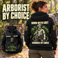 Black Arborist By Choice Vintage Hoodie shown on an off-duty woman in a woodland yard, with large BORN WITH GRIT back artwork and a smaller full front view.
