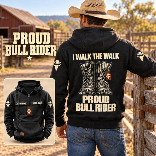 Black Bull Rider Proud Walk Vintage Hoodie worn by an adult cowboy at a sunlit corral, showing cream western boots and I WALK THE WALK / PROUD / BULL RIDER back artwork, with a smaller front view.