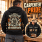 Black Carpenter Heritage Crest hoodie shown from the back in a woodworking shop, with readable carpenter-pride crest and a smaller front-detail inset.