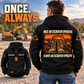 Black Excavator Operator Once and Always Vintage Hoodie on a back-view model beside a parked excavator, with boot-and-excavator artwork and a smaller front-view inset.