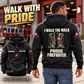 Black Firefighter Proud Walk Vintage Hoodie on an off-duty model outside a fire station, with boots-and-tag back artwork and a smaller front view.
