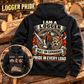 Black Logger Heritage Crest Vintage Hoodie on a timber bench, with a large logger back crest and smaller front-view inset showing CUSTOM NAME and SINCE 2000.