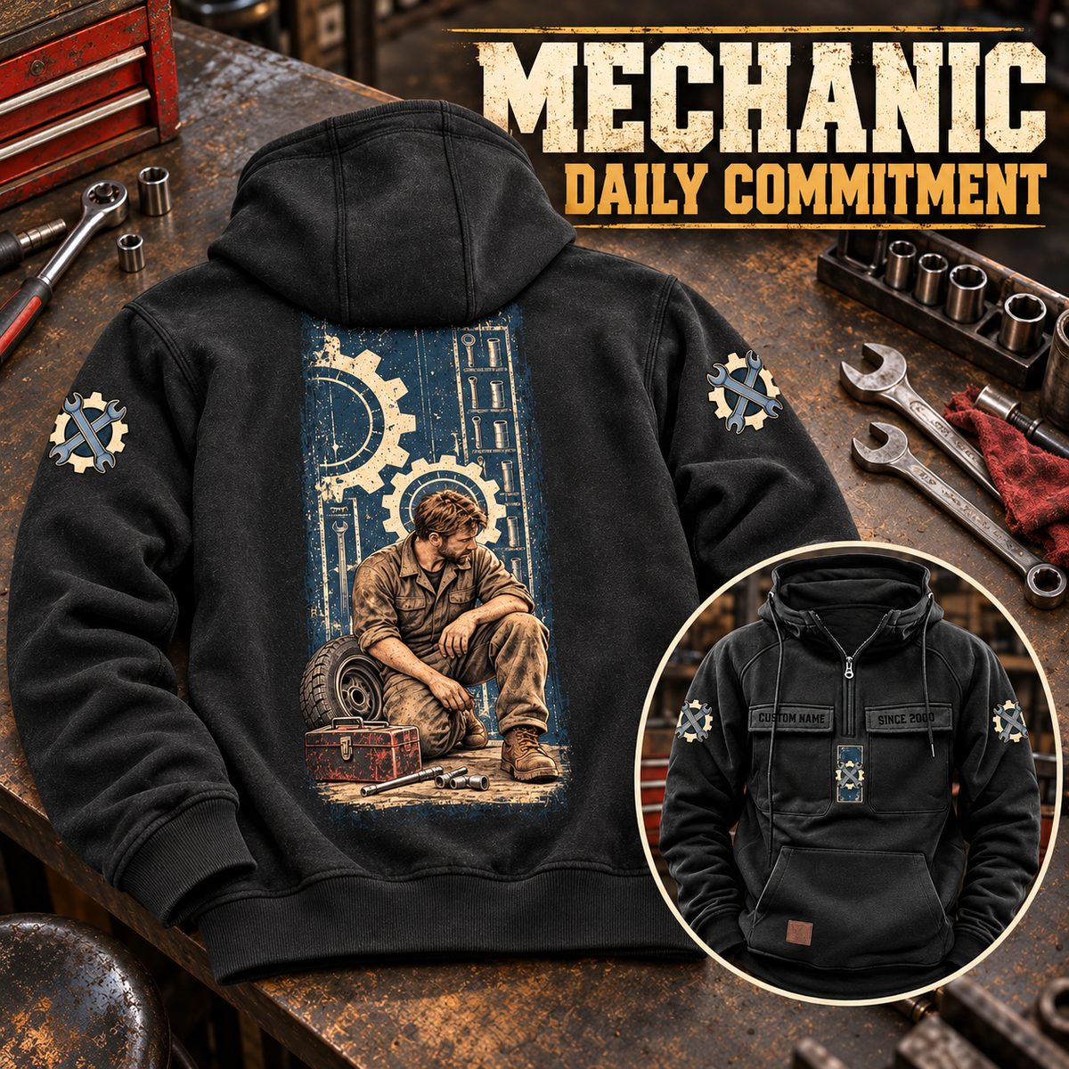 Black Mechanic Daily Commitment hoodie on a workshop bench, showing its tall mechanic portrait and a smaller front view with chest pockets and ring-pull half zip.
