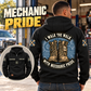 Black Mechanic Walk the Walk Badge hoodie worn from the back at a quiet workshop, showing tan boots and arched mechanic-pride text, with a smaller front view.