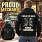 Black Mechanic Proud Walk Vintage Hoodie on a gray-haired man in a garage, showing boots and I WALK THE WALK / PROUD MECHANIC back artwork with a front-view inset.