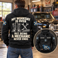 Black Mechanic Never Ends hoodie on an off-duty adult in a garage, with boots and wrench back artwork and a smaller front-view inset.