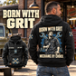Black Mechanic By Choice Vintage Hoodie worn from the back beside a parked vintage truck, showing cream and blue mechanic artwork and a smaller front-view inset.