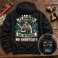 Black Plumber Heritage Crest Vintage Hoodie with cream and teal back artwork on a plumbing workbench, plus a smaller front-view inset.
