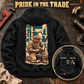 Black Plumber Workday Portrait hoodie with kneeling-plumber back artwork on a plumbing workbench and a smaller front inset.