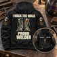 Black Welder Proud Walk Vintage Hoodie with large boot-and-lettering back view and smaller front inset on an off-duty welding workshop bench.